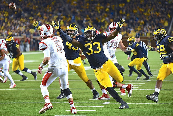 Taco Charlton (33), Chris Wormley (43), James Ross (15), and Willie Henry (69)