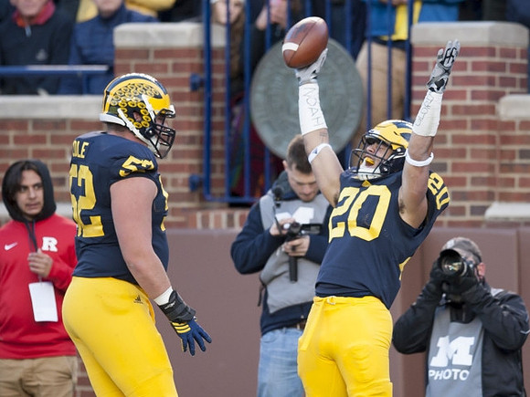 Mason Cole (52) and Drake Johnson (20)