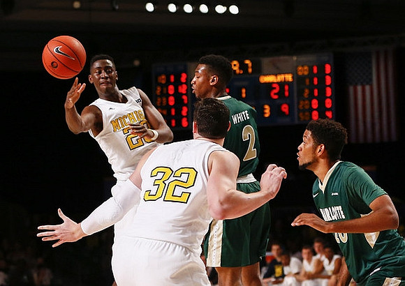 Caris LeVert (23) and Ricky Doyle (32)