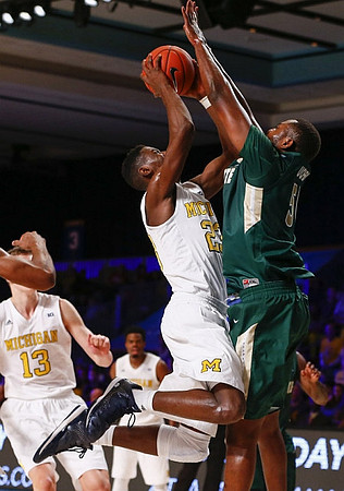Moritz Wagner (13), Derrick Walton Jr. (10), and Caris LeVert (23)