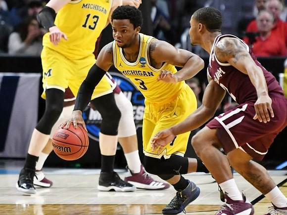 Moritz Wagner (13) and Zavier Simpson (3)