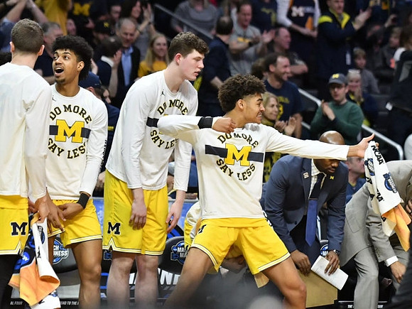 Duncan Robinson (22), Ibi Watson (23), Jon Teske (15), and Jordan Poole (2)