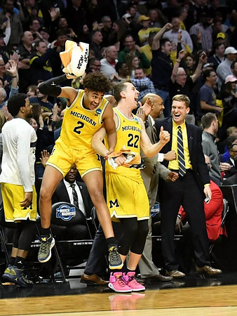 Zavier Simpson (3), Jordan Poole (2), Duncan Robinson (22), Saddi Washington, and Luke Yaklich