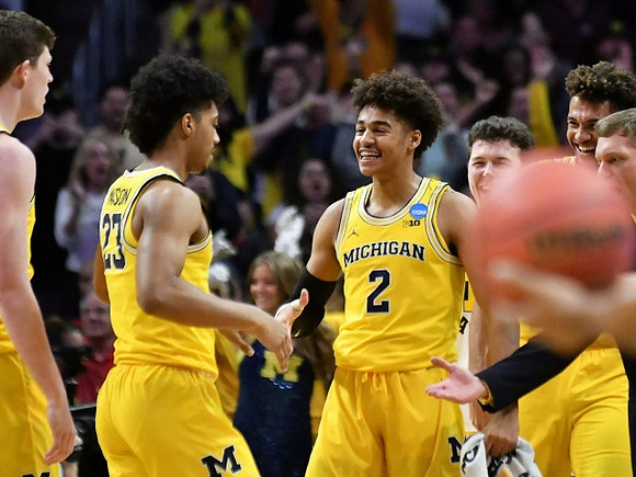 Jon Teske (15), Ibi Watson (23), Jordan Poole (2), C.J. Baird (24), Isaiah Livers (4), and Luke Yaklich