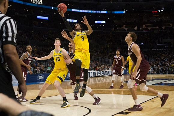 Jon Teske (15), Zavier Simpson (3), and Muhammad-Ali Abdur-Rahkman (12)