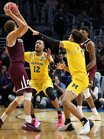 Muhammad-Ali Abdur-Rahkman (12) and Isaiah Livers (4)