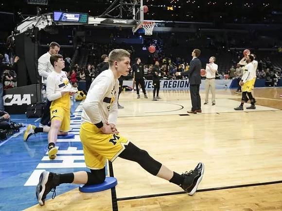 Moritz Wagner (13), Jon Teske (15), Austin Hatch (30), and Zavier Simpson (3)