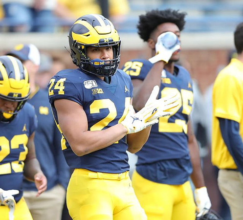 Jordan Castleberry (23), Zach Charbonnet (24), and Hassan Haskins (25)