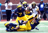 Vincent Gray (31), Khaleke Hudson (7), Daxton Hill (30), and Brad Hawkins (20)