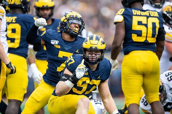 Kwity Paye (19), Khaleke Hudson (7), Aidan Hutchinson (97), and Michael Dwumfour (50)