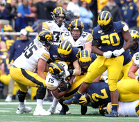 Aidan Hutchinson (97), Khaleke Hudson (7), Carlo Kemp (2), and Michael Dwumfour (50)