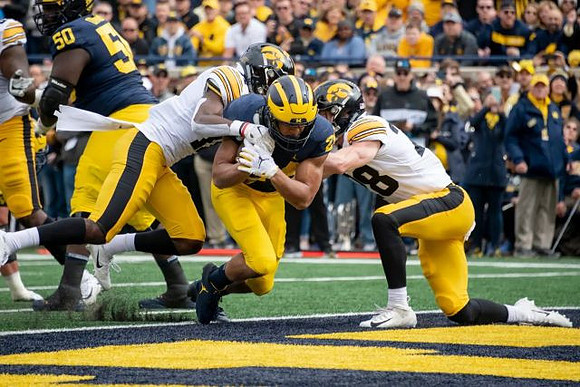 Michael Onwenu (50) and Zach Charbonnet (24)