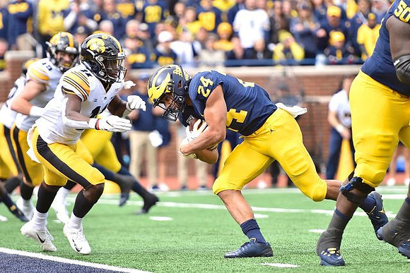 Zach Charbonnet (24) and Michael Onwenu (50)