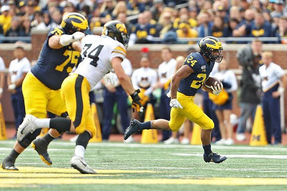 Jon Runyan Jr. (75) and Zach Charbonnet (24)