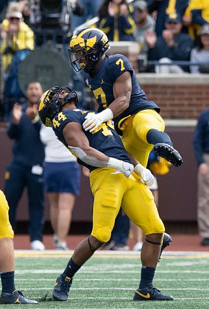 Cameron McGrone (44) and Khaleke Hudson (7)