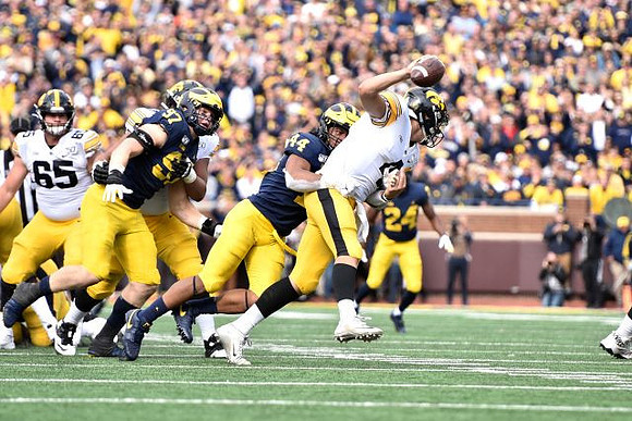 Aidan Hutchinson (97), Cameron McGrone (44), and Lavert Hill (24)