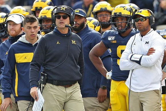 Jay Harbaugh, Jim Harbaugh, Donovan Peoples-Jones (9), and Roy Roundtree