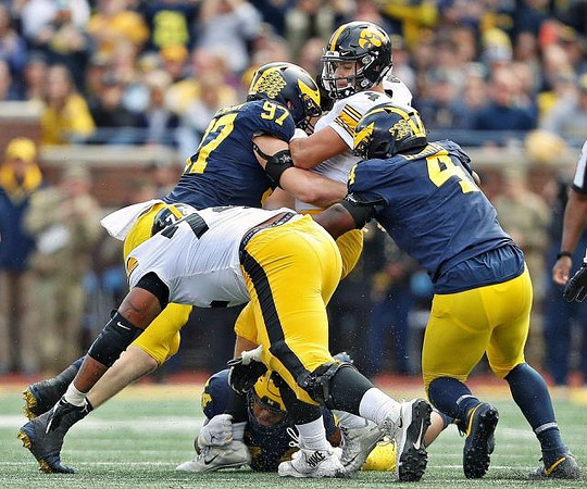Cameron McGrone (44), Aidan Hutchinson (97), and Michael Danna (4)