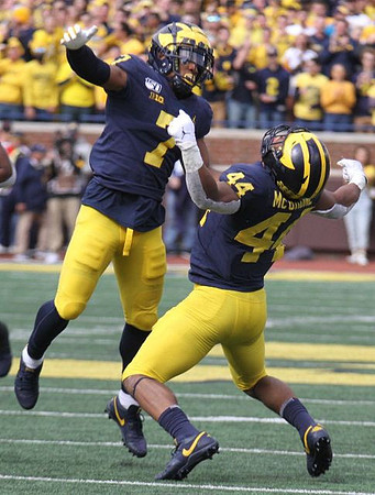 Khaleke Hudson (7) and Cameron McGrone (44)