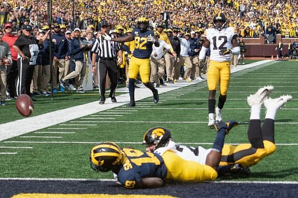 Mike Sainristil (19) and Nick Eubanks (82)