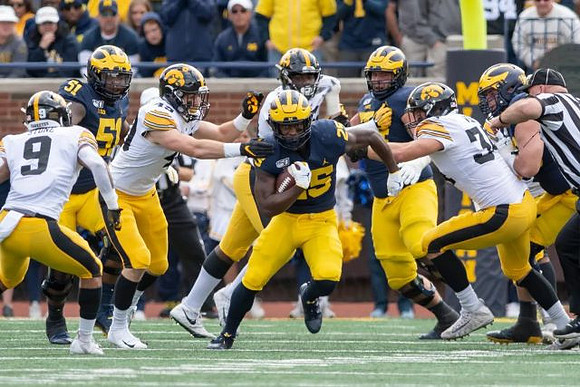 Cesar Ruiz (51), Hassan Haskins (25), Jalen Mayfield (73), and Ben Bredeson (74)