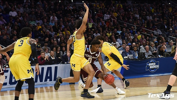 Zavier Simpson (3), Ibi Watson (23), and Isaiah Livers (4)