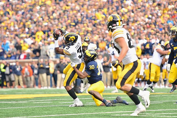 Daxton Hill (30) and Khaleke Hudson (7)