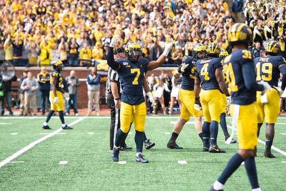 Lavert Hill (24), Khaleke Hudson (7), Aidan Hutchinson (97), Michael Danna (4), Vincent Gray (31), and Kwity Paye (19)