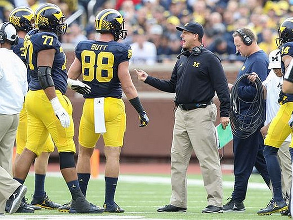 Grant Newsome (77), Jake Butt (88), Jim Harbaugh, and Tim Drevno
