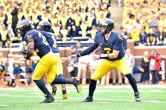 Karan Higdon (22), Ambry Thomas (1), and Shea Patterson (2)