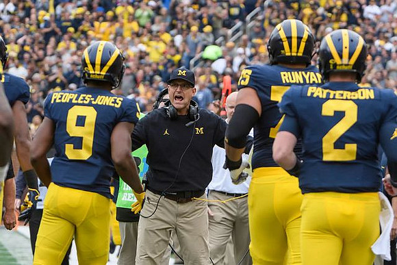 Donovan Peoples-Jones (9), Jim Harbaugh, Jon Runyan Jr. (75), and Shea Patterson (2)