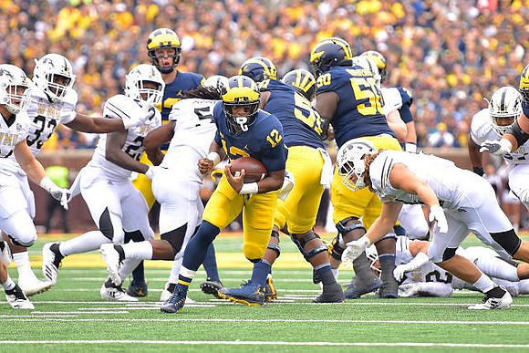 Shea Patterson (2), Chris Evans (12), Cesar Ruiz (51), and Michael Onwenu (50)