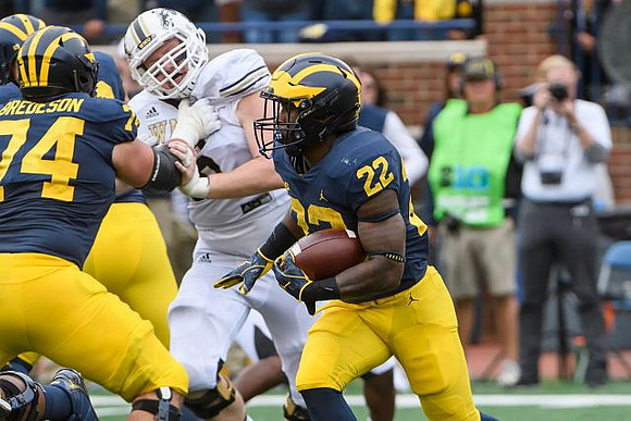 Ben Bredeson (74) and Karan Higdon (22)