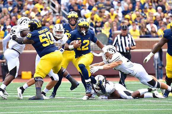Michael Onwenu (50), Chris Evans (12), and Shea Patterson (2)