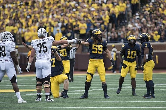 Aidan Hutchinson (97), Brad Hawkins (20), Noah Furbush (59), Devin Bush (10), and Khaleke Hudson (7)