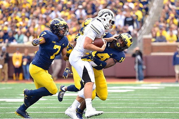 Khaleke Hudson (7), Lavert Hill (24), and Josh Metellus (14)