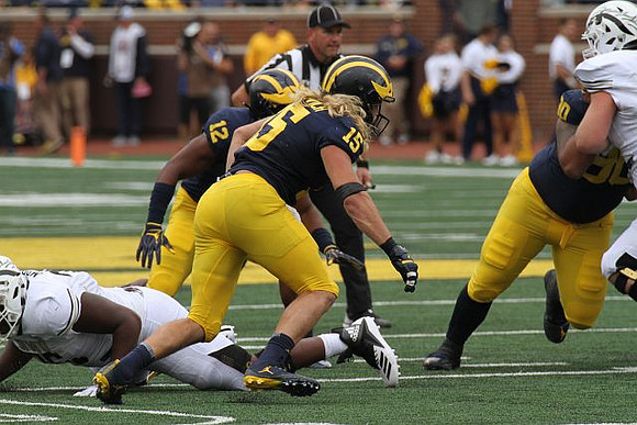 Josh Ross (12), Chase Winovich (15), and Bryan Mone (90)
