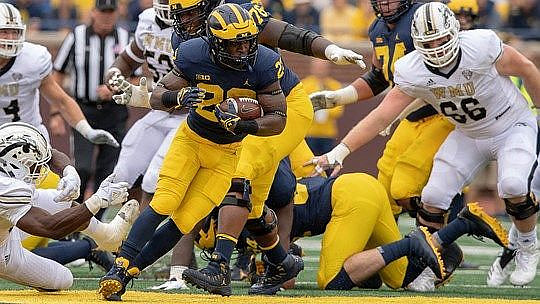 Karan Higdon (22) and Ben Bredeson (74)