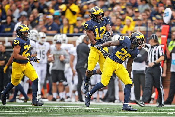 Tyree Kinnel (23), Josh Ross (12), and Brad Hawkins (20)