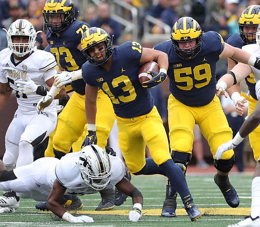 Tru Wilson (13), Jalen Mayfield (73), and Joel Honigford (59)