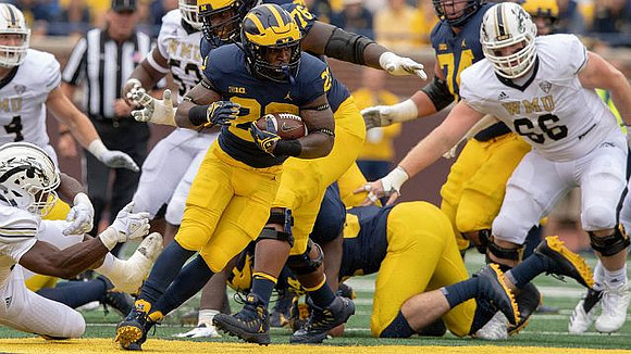 Karan Higdon (22) and Ben Bredeson (74)