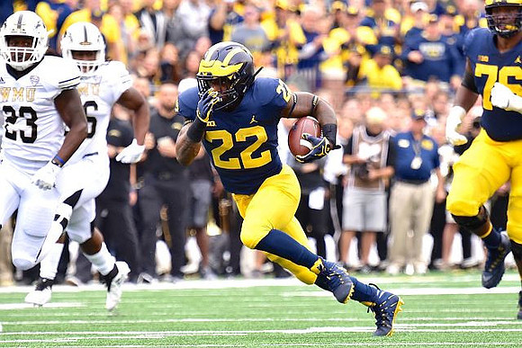 Karan Higdon (22) and Juwann Bushell-Beatty (76)