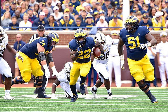 Ben Bredeson (74), Karan Higdon (22), and Cesar Ruiz (51)