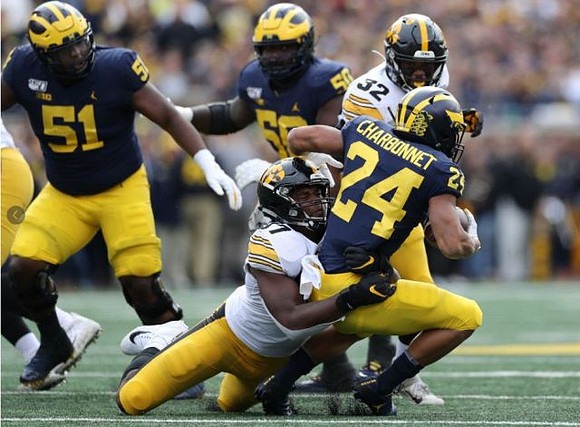 Cesar Ruiz (51), Zach Charbonnet (24), and Michael Onwenu (50)