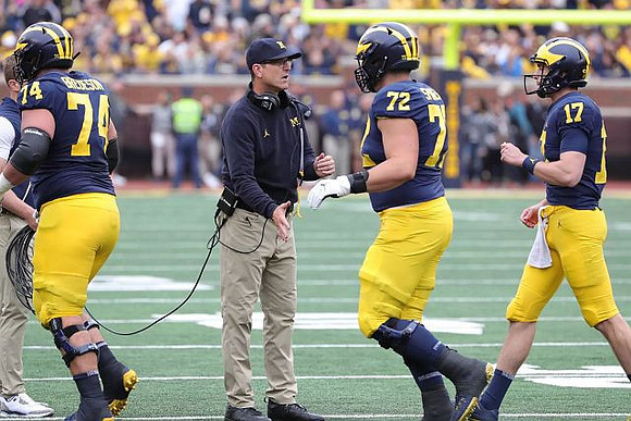 Ben Bredeson (74), Jim Harbaugh, Stephen Spanellis (72), and Will Hart (17)
