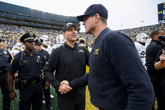 Western Michigan Head Coach Tim Lester and Jim Harbaugh