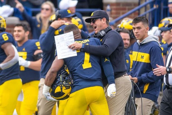 Khaleke Hudson (7) and Jim Harbaugh