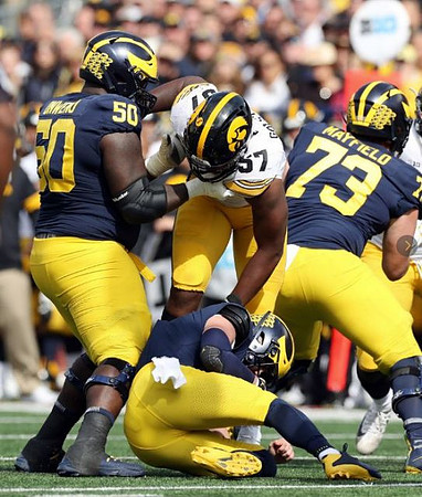 Michael Onwenu (50), Shea Patterson (2), and Jalen Mayfield (73)