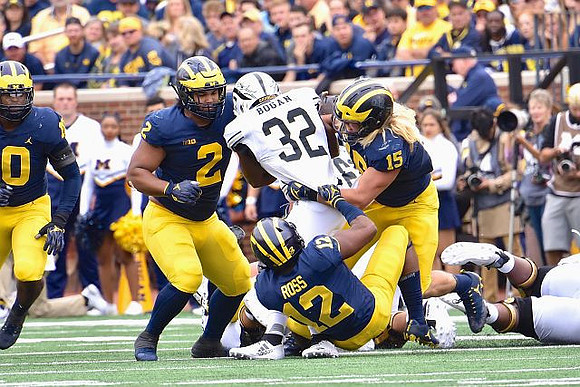 Devin Bush (10), Carlo Kemp (2), Josh Ross (12), and Chase Winovich (15)