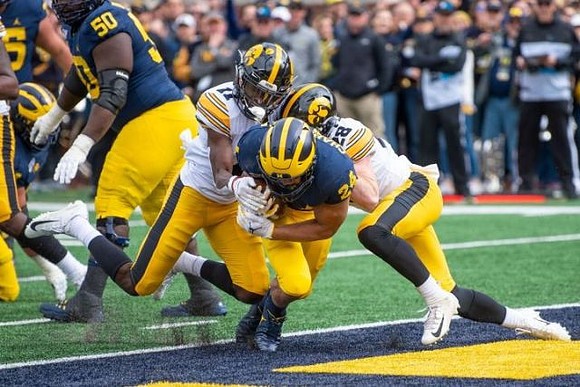 Michael Onwenu (50) and Zach Charbonnet (24)
